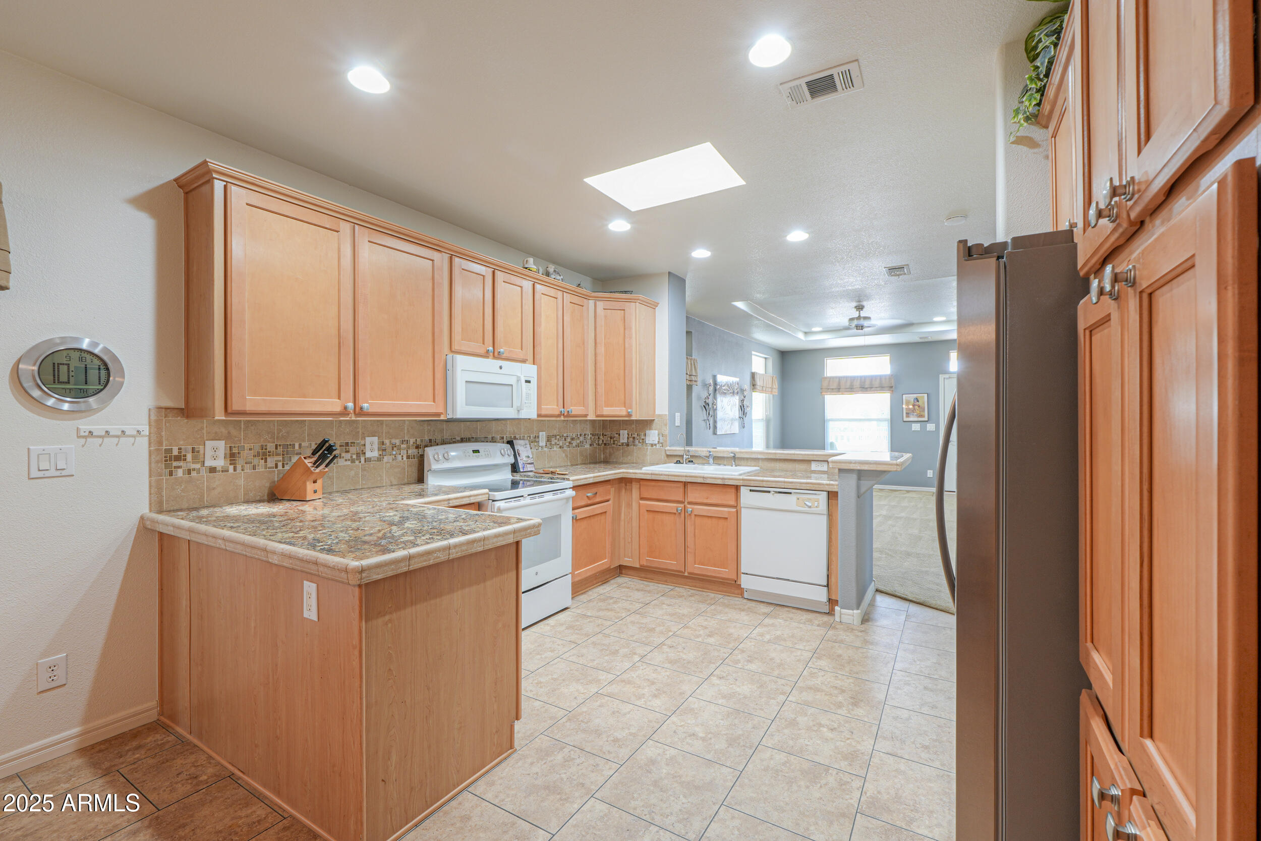 2263 North Trekell Road, Unit 36 Casa Grande, AZ 85122 - Photo 12 of 53 a kitchen with a refrigerator sink and cabinets