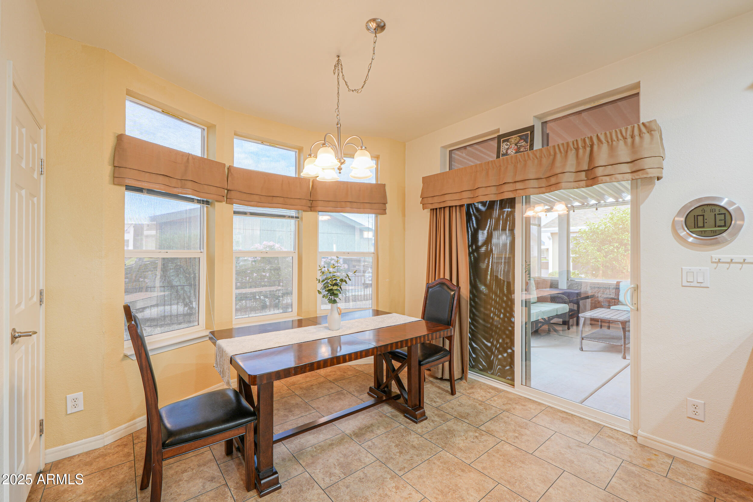 2263 North Trekell Road, Unit 36 Casa Grande, AZ 85122 - Photo 15 of 53 a dining room with furniture and a floor to ceiling window