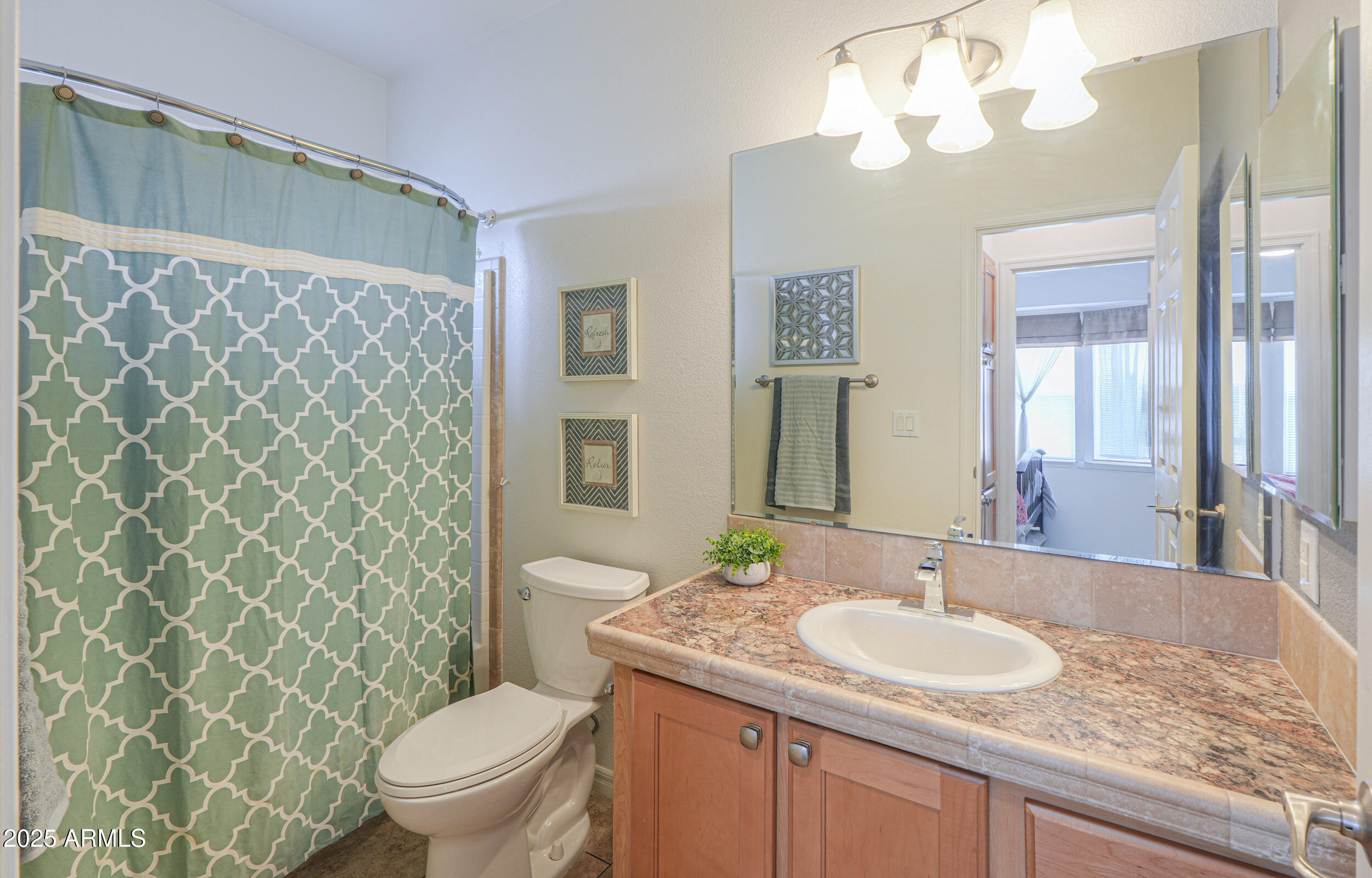 2263 North Trekell Road, Unit 36 Casa Grande, AZ 85122 - Photo 19 of 53 a bathroom with a granite countertop sink a toilet and a mirror
