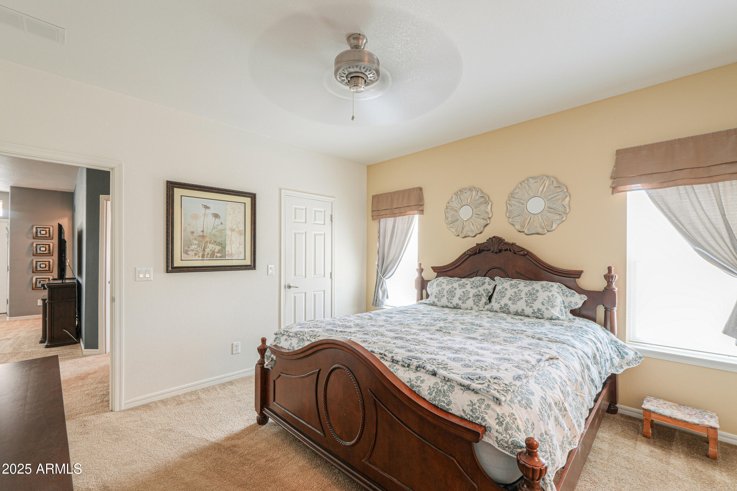 2263 North Trekell Road, Unit 36 Casa Grande, AZ 85122 - Photo 22 of 53 a bedroom with a bed and painting on the wall