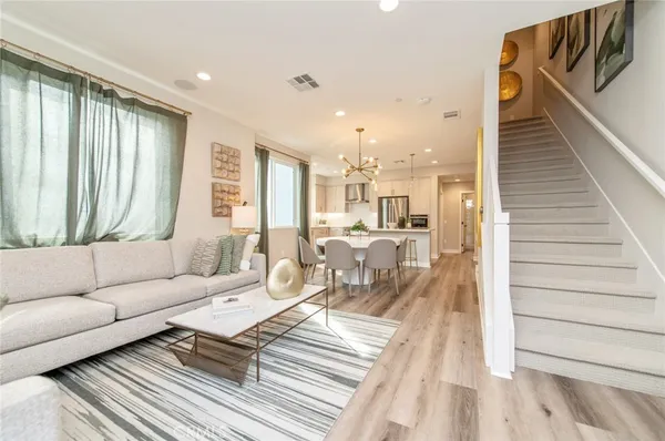 a view of a a dining room with furniture window and wooden floor