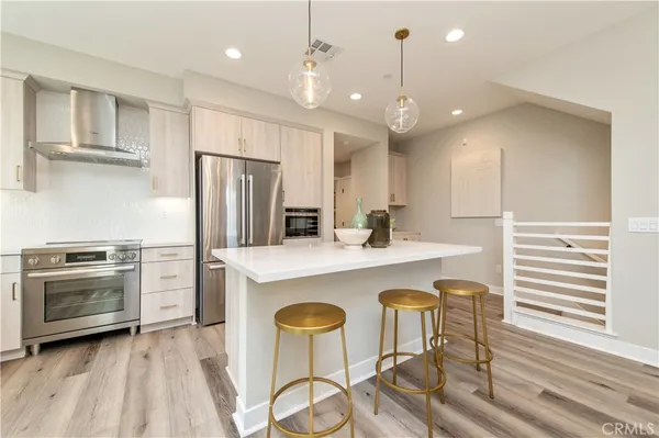 a large kitchen with a table and chairs in it