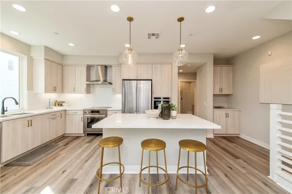 a kitchen with a dining table chairs sink and cabinets