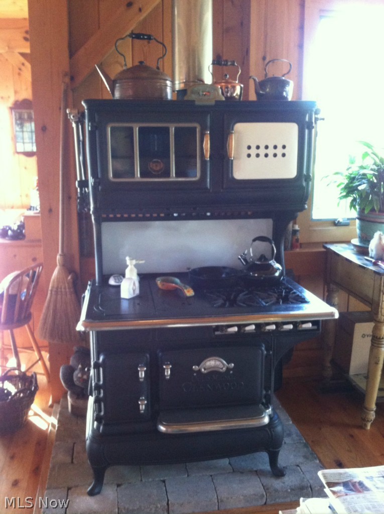 12463 Pond Road Burton, OH 44021 - Photo 20 of 23 Fully restored 1830's Gold Medal Glenwood stove with fully operational gas and wood burning burners, ovens and broilers. A normal full electric oven is also included with the house.
