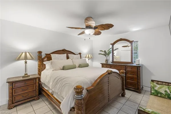 a bedroom with a bed and a dresser