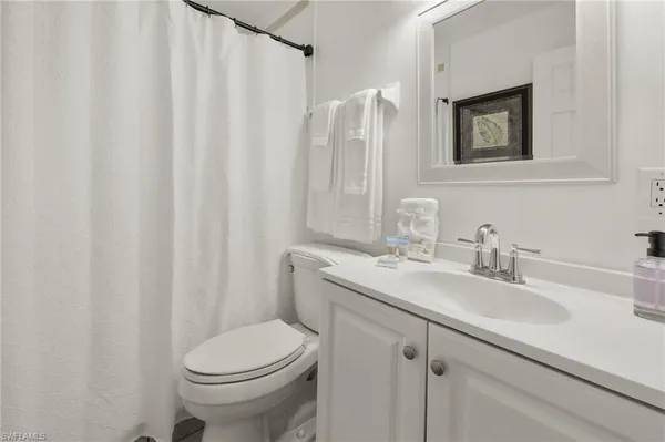 a bathroom with a tub a rug and a shower
