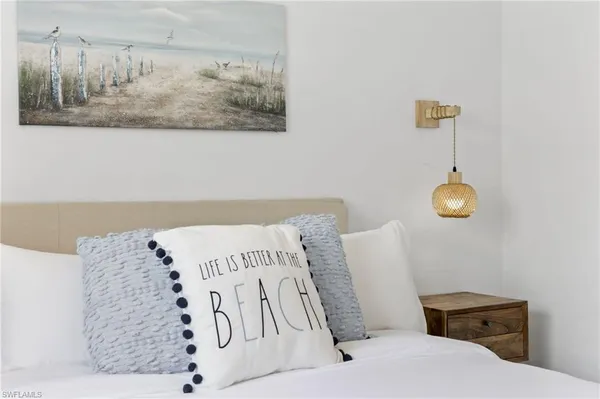 a white bed with white walls