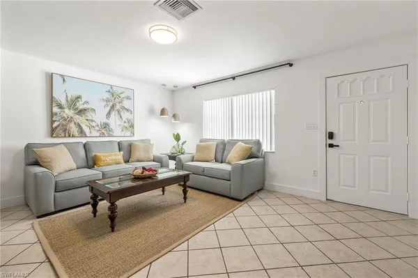 a living room with furniture and a rug