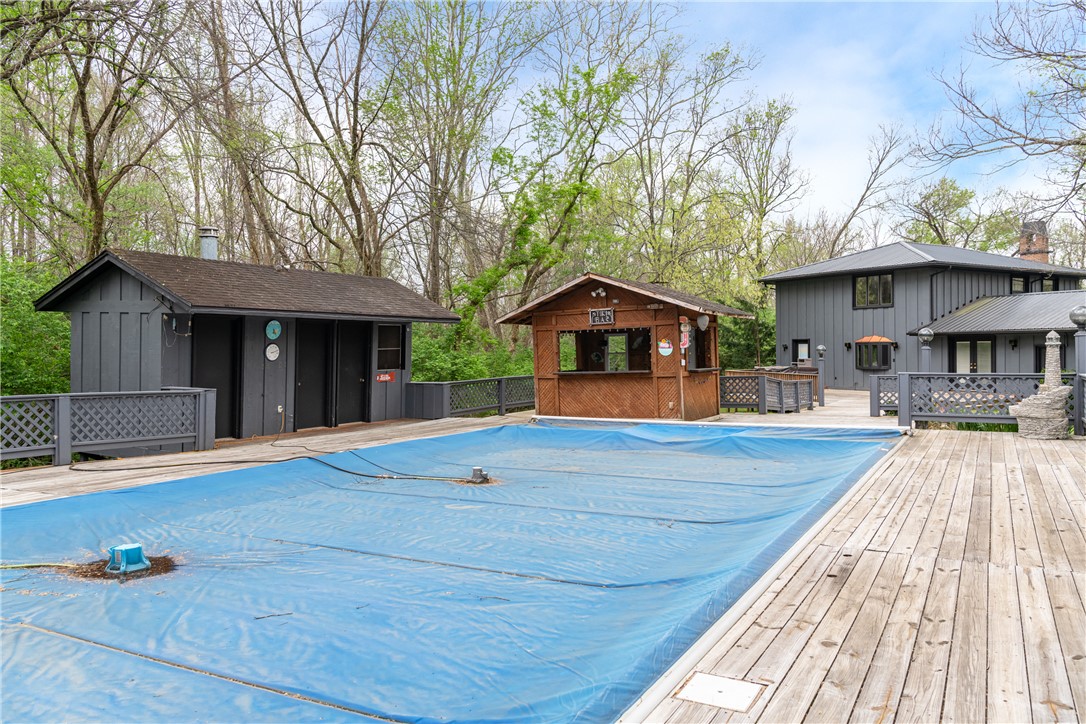 6750 Little Twin Road Germantown, OH 45327 - Photo 41 of 88 An inviting backyard oasis features a covered pool and expansive wooden deck, perfect for entertaining.