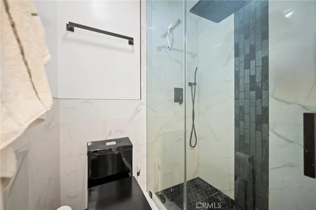 a bathroom with a shower and a sink