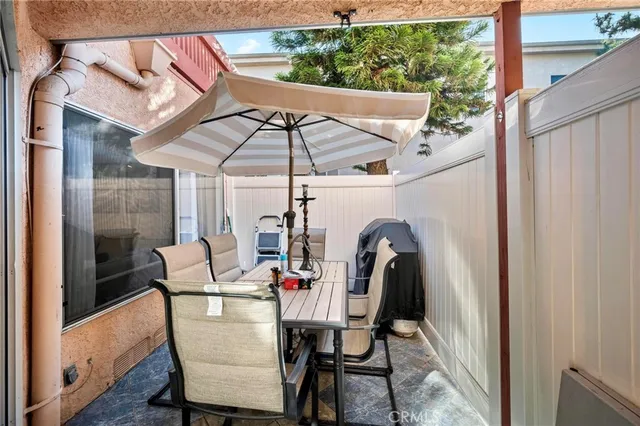 a view of a patio with a table and chairs