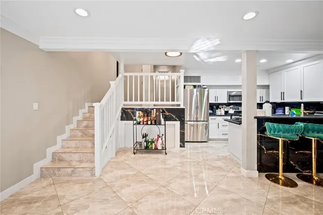 a view of a kitchen with furniture and staircase