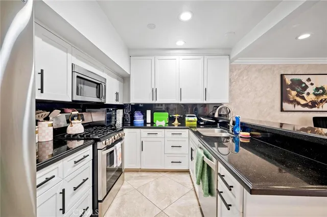 a kitchen with a stove sink and cabinets