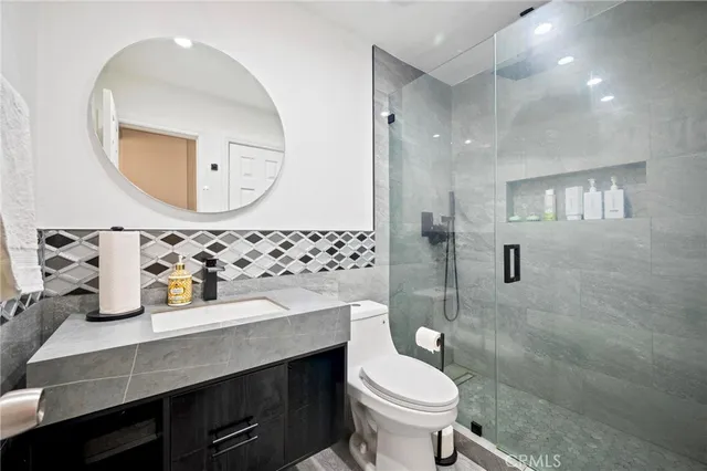 a bathroom with a sink toilet and shower