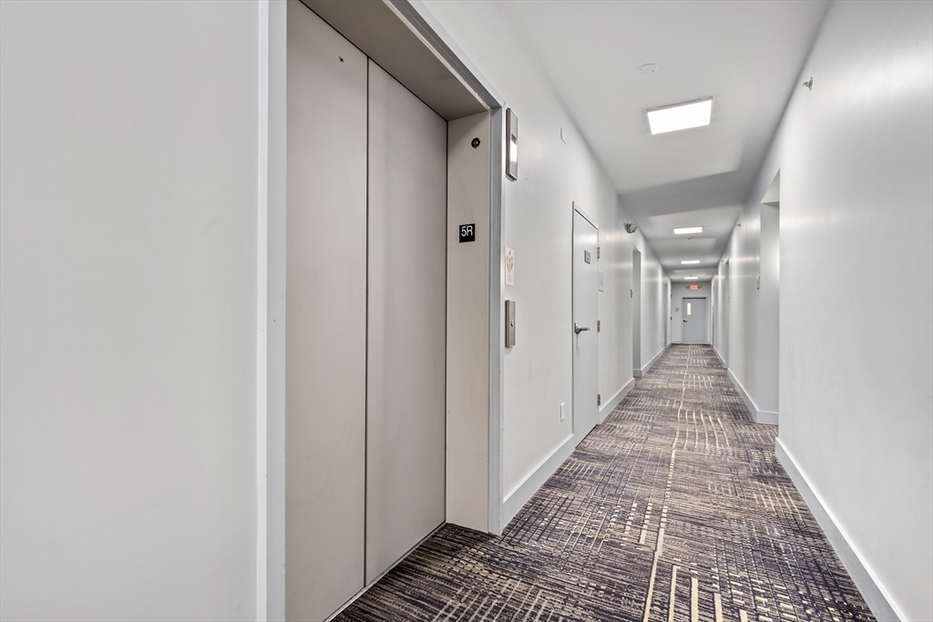70 Bremen Street, Unit 501 Boston, MA 02128 - Photo 14 of 15 a view of a hallway with wooden floor and a bathroom