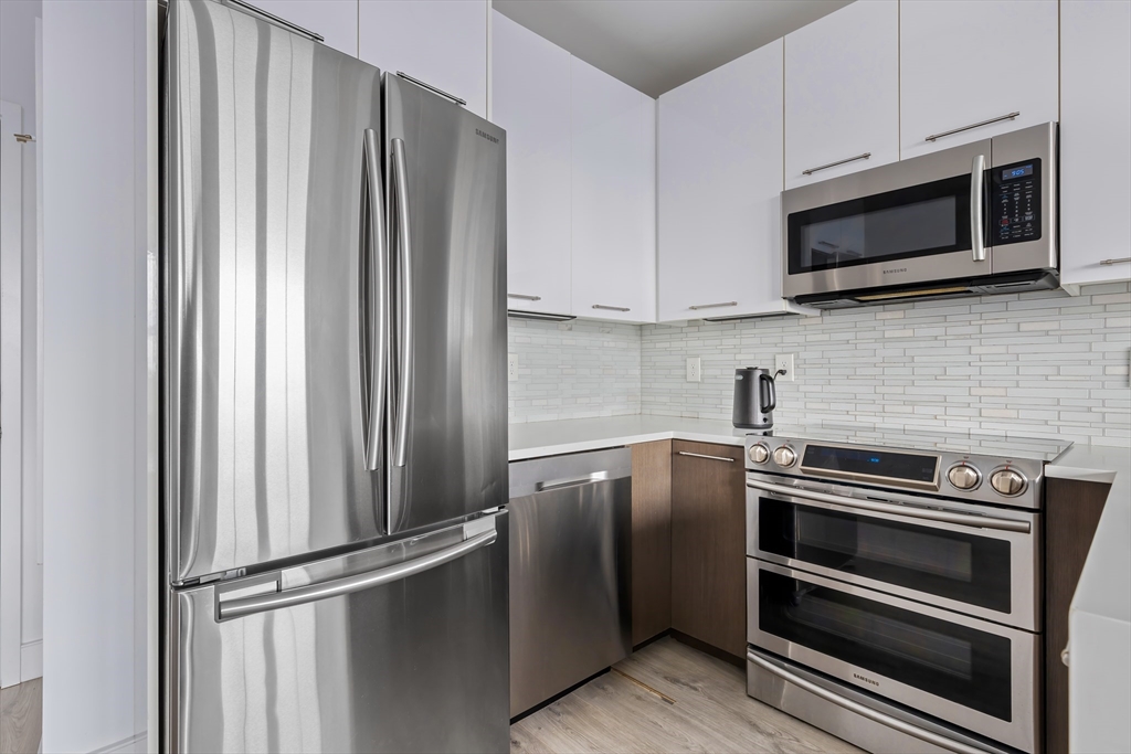 70 Bremen Street, Unit 501 Boston, MA 02128 - Photo 5 of 15 a kitchen with stainless steel appliances and granite countertop
