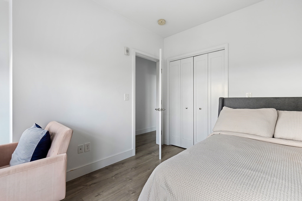 70 Bremen Street, Unit 501 Boston, MA 02128 - Photo 7 of 15 a bedroom with a bed and wooden floor