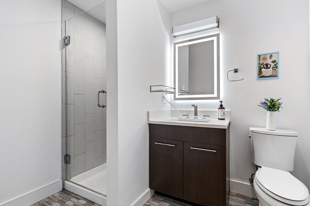 70 Bremen Street, Unit 501 Boston, MA 02128 - Photo 9 of 15 a bathroom with a sink a toilet and shower