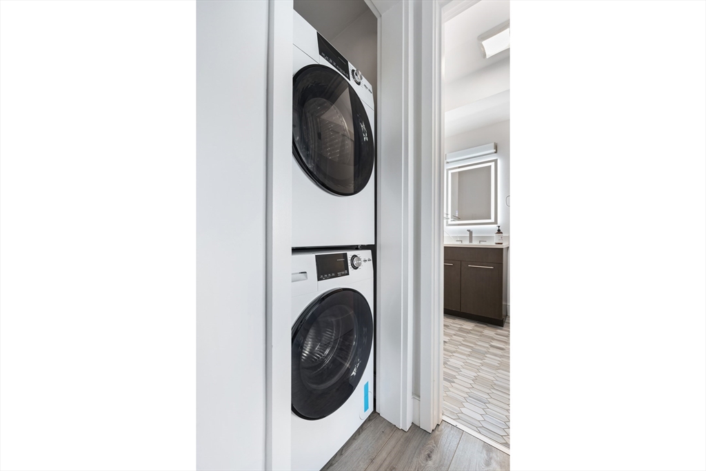 70 Bremen Street, Unit 501 Boston, MA 02128 - Photo 10 of 15 a view of a hallway with washer and dryer