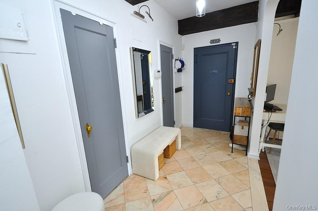 192 Garth Road, Unit TP Scarsdale, NY 10583 - Photo 33 of 43 A stunning marble-floored entry welcomes you into a light-filled home featuring charming courtyard views, soaring wood-beamed ceilings, gleaming hardwood floors, and an impressive eight oversized closets for exceptional storage.