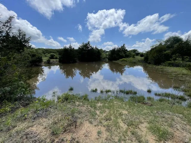 an aerial view of lake and houses with outdoor space