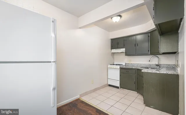 a kitchen with stainless steel appliances granite countertop a sink and a stove top oven