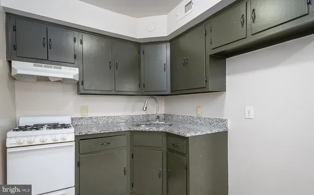 a kitchen with stainless steel appliances granite countertop a sink stove and cabinets
