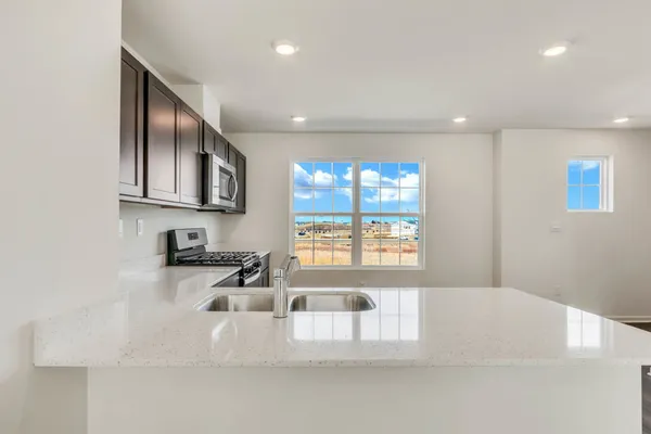 a kitchen with stainless steel appliances granite countertop a stove and a sink