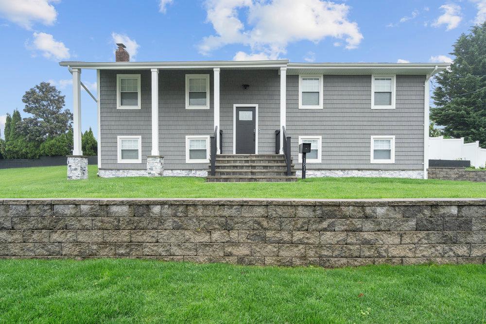 a front view of a house with a yard