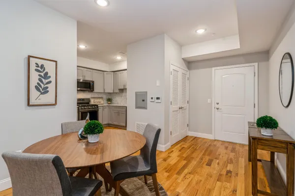 a view of a dining room with furniture and wooden floor
