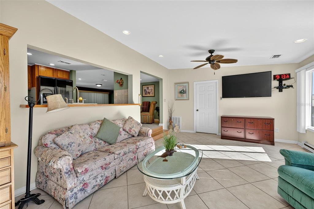 945 Todd Way Tavares, FL 32778 - Photo 19 of 75 a living room with furniture and a flat screen tv