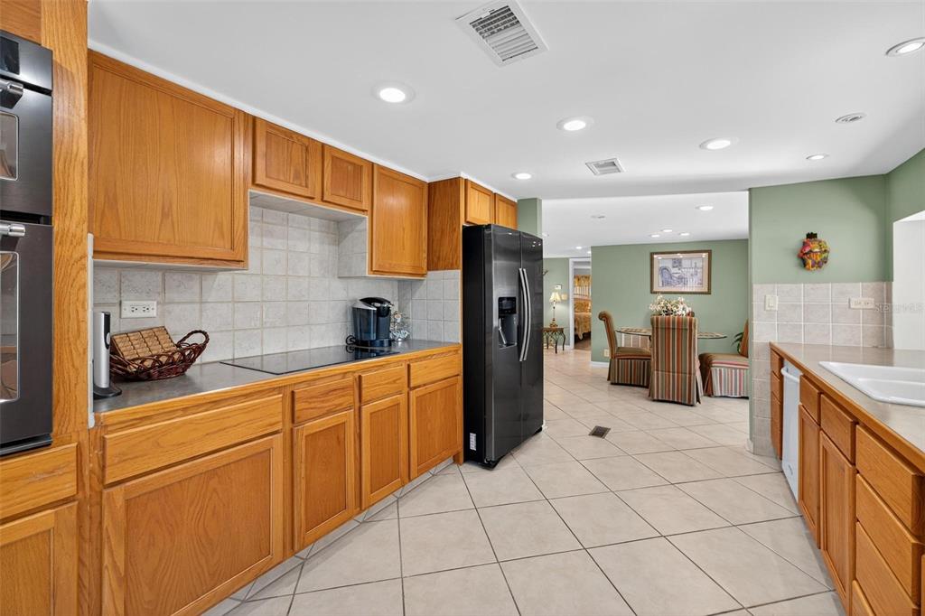 945 Todd Way Tavares, FL 32778 - Photo 27 of 75 a kitchen with stainless steel appliances granite countertop a refrigerator sink and cabinets