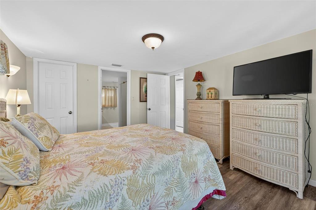 945 Todd Way Tavares, FL 32778 - Photo 31 of 75 a bedroom with a bed and a flat tv screen on dresser