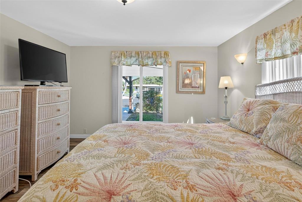 945 Todd Way Tavares, FL 32778 - Photo 33 of 75 a bedroom with a large bed and a flat screen tv