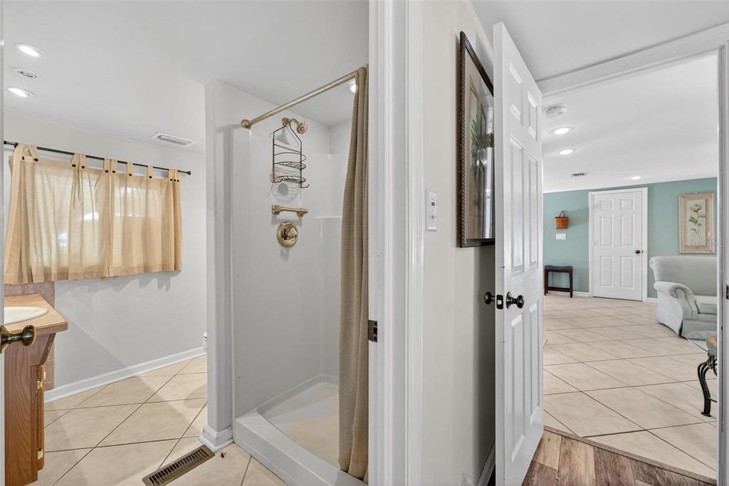 945 Todd Way Tavares, FL 32778 - Photo 34 of 75 a bathroom with a shower and a glass door