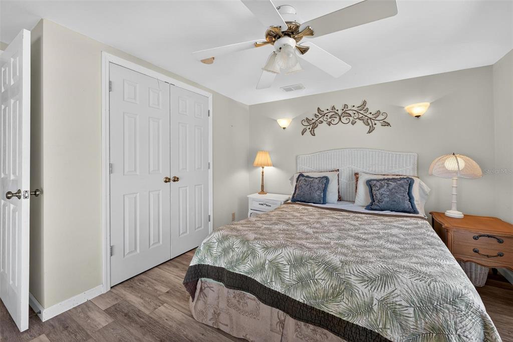 945 Todd Way Tavares, FL 32778 - Photo 39 of 75 a bedroom with a bed and a chandelier