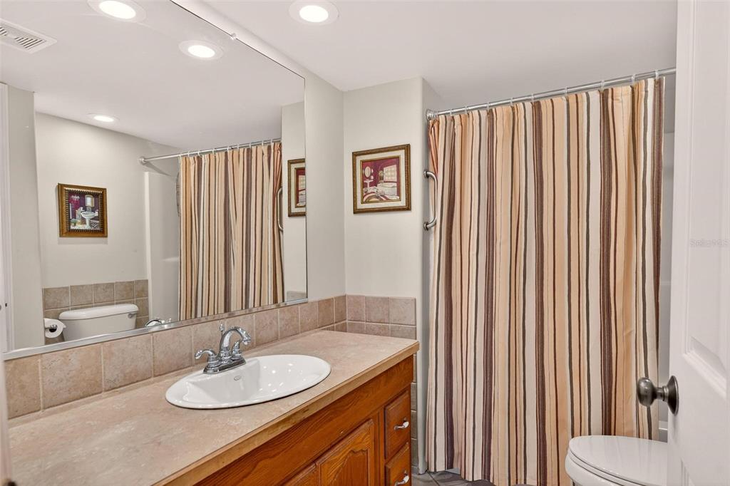 945 Todd Way Tavares, FL 32778 - Photo 41 of 75 a bathroom with a sink a toilet and mirror