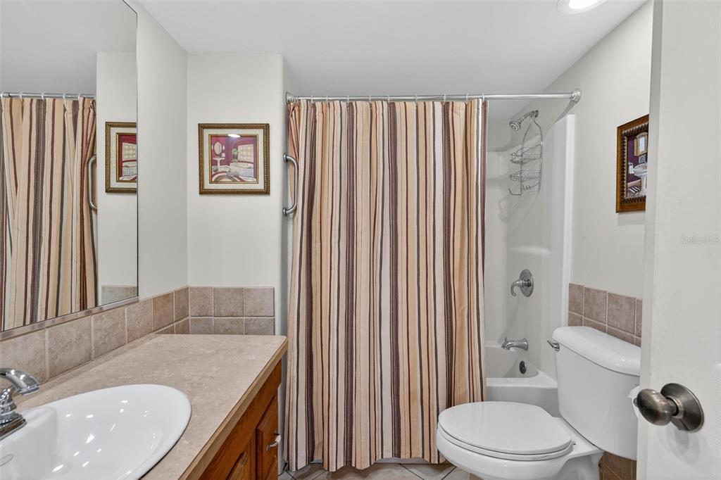 945 Todd Way Tavares, FL 32778 - Photo 42 of 75 a bathroom with a granite countertop sink toilet and shower