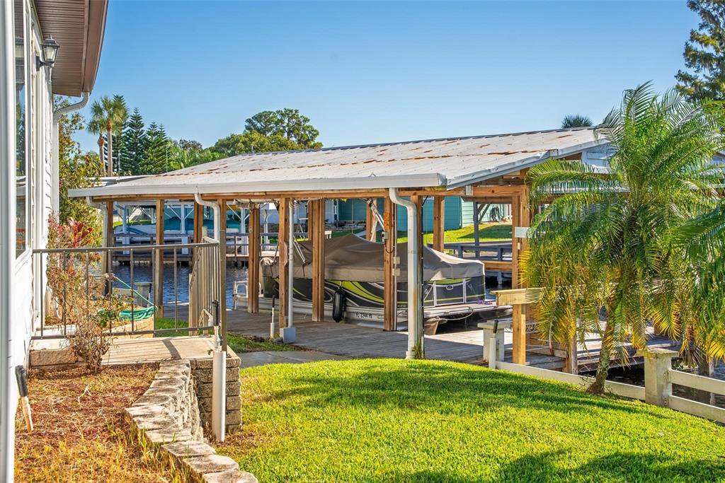 945 Todd Way Tavares, FL 32778 - Photo 50 of 75 a view of a house with a backyard porch and sitting area