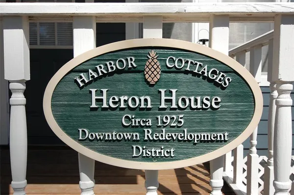 a view of a yard in front of a house with large tree