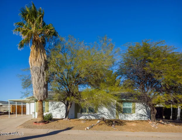 a view of a tree in front of a house