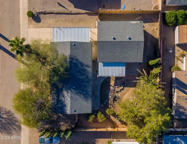 an aerial view of a house with a yard and large tree