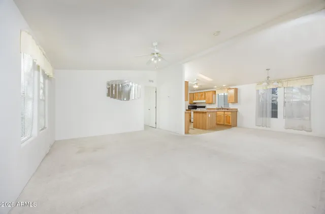 an empty room with a kitchen and a sink