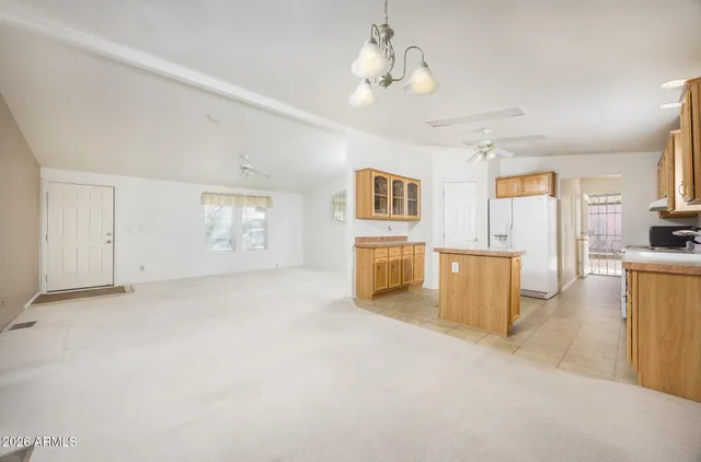 a view of a livingroom with furniture cabinet and chandelier