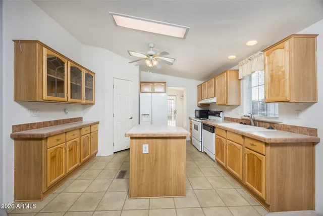 a large kitchen with stainless steel appliances granite countertop a stove a sink dishwasher and a refrigerator