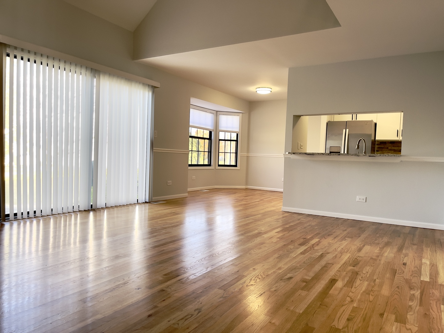 4480 Opal Drive Hoffman Estates, IL 60192 - Photo 5 of 18 an empty room with wooden floor and windows