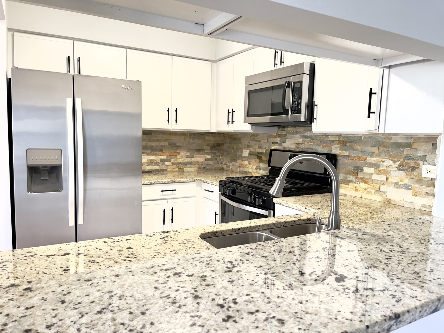 4480 Opal Drive Hoffman Estates, IL 60192 - Photo 7 of 18 a kitchen with granite countertop a refrigerator and a stove top oven