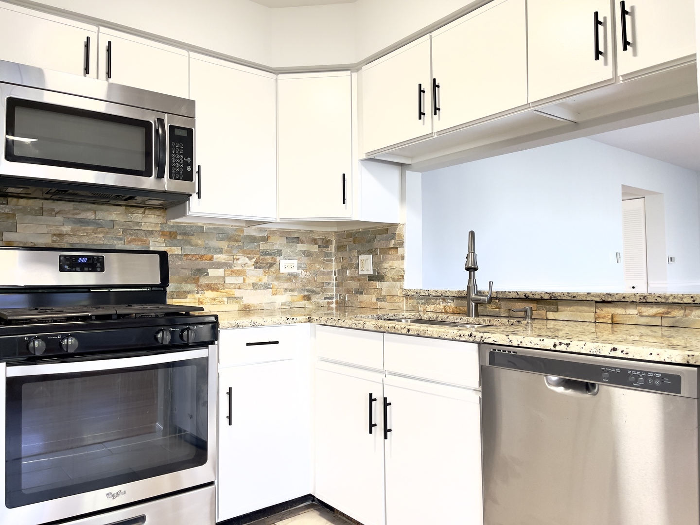 4480 Opal Drive Hoffman Estates, IL 60192 - Photo 8 of 18 a kitchen with stainless steel appliances a stove microwave and sink