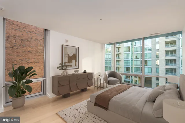 a bedroom with a bed and glass window