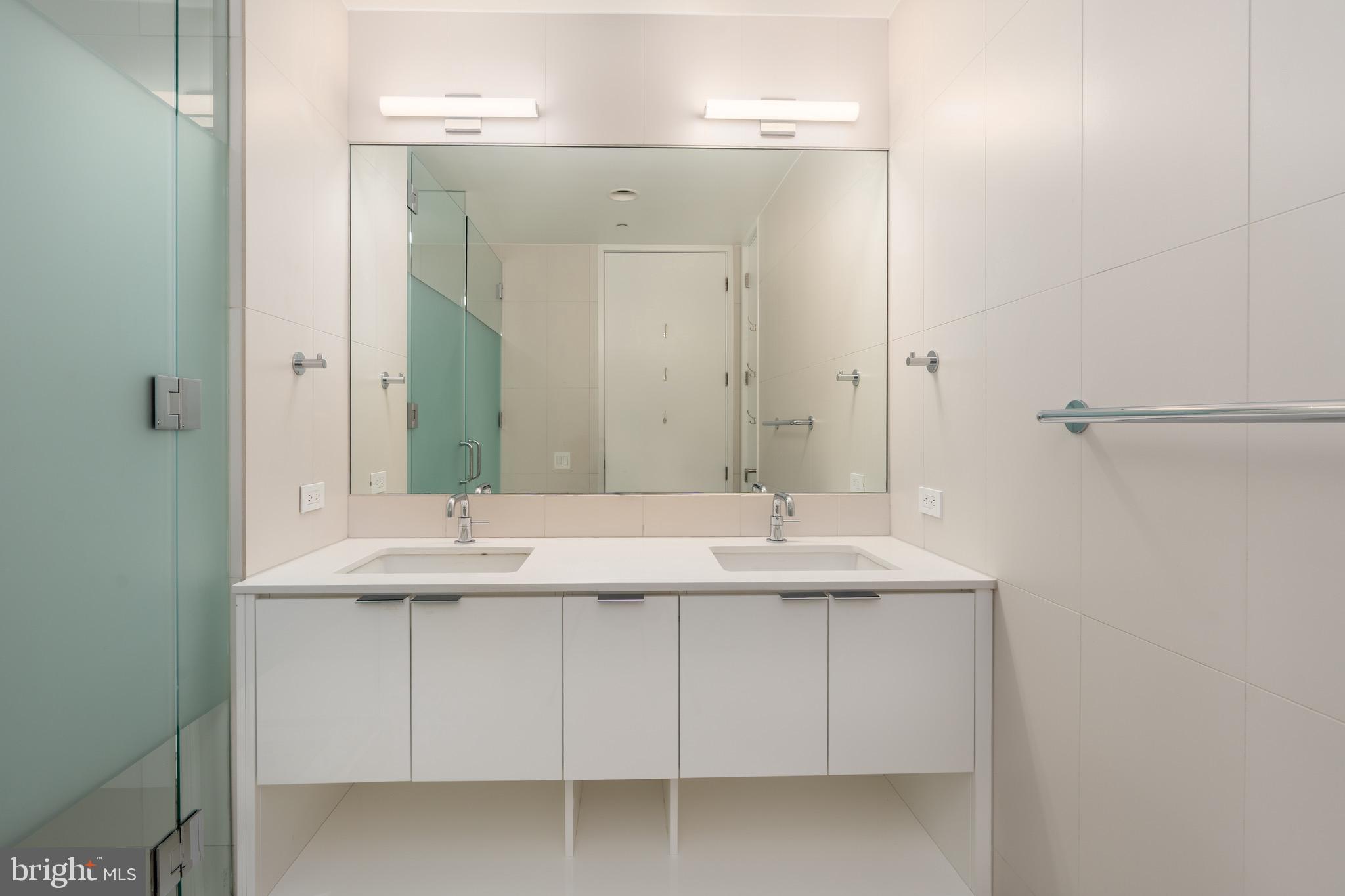 1110 23rd Street Northwest, Unit 505 Washington, DC 20037 - Photo 7 of 25 a bathroom with a sink and a mirror